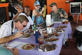 Judges sample ribs from a dozen contestants.
